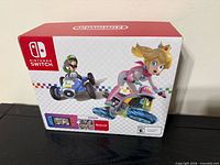 Front of Mario Kart 8 Deluxe Nintendo Switch bundle box showing Luigi and Princess Peach artwork
