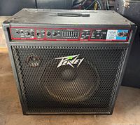 Front view of Peavey TNT 115 amplifier showing grille, logo, control panel
