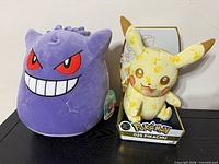 Front view showing Gengar plush and boxed Pikachu
