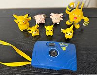 Group shot showing all figures and camera