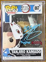 Front view of autographed Tanjiro Kamado Funko Pop #867 in protector case showing signature and special edition sticker