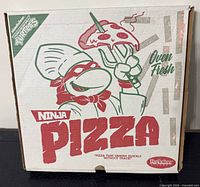 Front of Ninja Pizza box showing branding and graphics