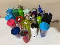 Group of assorted tumblers and bottles on table