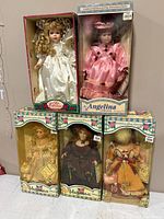 Five boxed dolls displayed