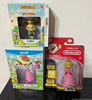 All three sealed Nintendo items displayed together