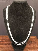 Full view of two-strand pearl necklace on display bust