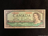 Front of 1954 $1 note showing portrait, serial number 5239981, signatures