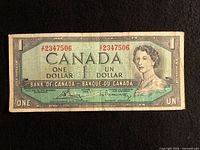 Front of 1954 Canada $1 banknote showing serial Y2347506, signatures, portrait