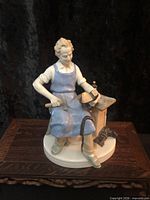 Front view of cobbler figurine on wooden stand