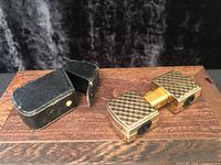 Opera glasses and case on wood surface, both items visible