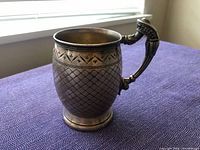 Full view of cup showing body pattern and handle
