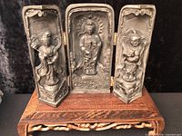 Triptych shrine fully opened on wooden stand