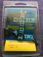 Front of sealed package showing turquoise bird-pattern harness