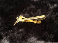 Tie clip side view showing fighter jet detail and textured bar