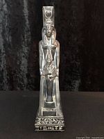 Front view showing full statue, headdress, wings and hieroglyphic base