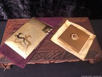 Cigarette case and compact with felt sleeves on display