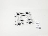 Top view of chrome cross trivet showing grid pattern and feet