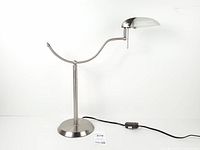 Full view of brushed nickel crescent table lamp, base to head, showing inline switch and cord