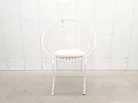Front view of white wire chair with cushion