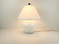 Lamp illuminated showing ceramic base and shade
