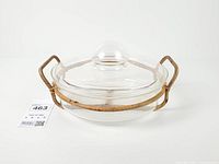 Full view of casserole dish with lid in rattan stand