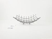 Side view showing curved lattice and ball feet