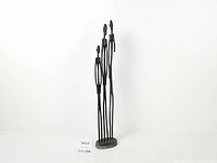 Full view of sculpture with three figures and base