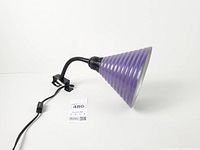 Whole lamp showing purple ribbed shade, gooseneck, clamp, cord and switch