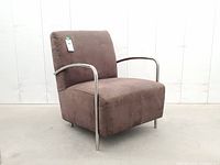 Front three-quarter view of armchair showing chrome arms and brown upholstery