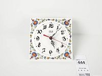 Front view of square ceramic floral clock