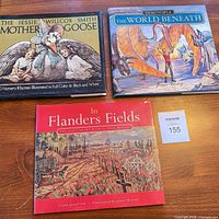 All three hardcover books laid out on table