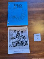 Script cover showing show title and multiple signatures; brass brads visible