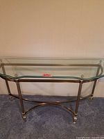 full view of glass top console table against wall