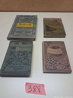 Group shot of four Victorian cloth-bound books