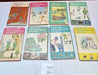 Nine hardcover Best in Children's Books volumes with dust jackets laid out