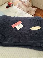 Folded navy blanket showing velvet border and king label