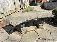 Full view of assembled concrete bench on stone patio