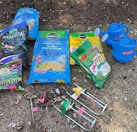 Overall view of soil bags, sprinklers, watering cans and clamps