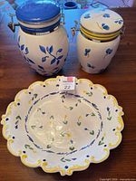 Front view of two canisters with bowl