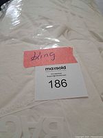 Comforter sealed in plastic with king size note and lot tag visible