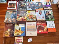Group shot of all 17 cookbooks laid out in four rows