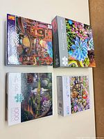 All four sealed 1000-piece puzzle boxes shown top view