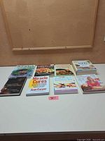 Eight books laid flat showing covers