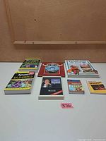 All seven books laid out on table