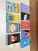 All nine Alexander McCall Smith paperbacks laid out face up