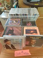 Overall lot: upright CDs in storage box plus two horizontal stacks