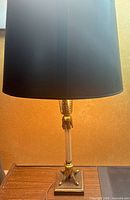 Full view lamp with shade on wooden surface