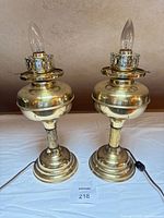 Full view of both brass table lamps with cords and bulbs