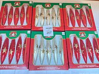 Six original boxes showing red and cream ornaments