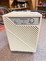 Front view showing brand, model, control panel and grille